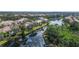 Overhead view of a lovely home surrounded by mature trees and a tranquil waterway at 5208 Parisienne Pl # 202B33, Sarasota, FL 34238