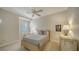 Bedroom featuring a ceiling fan, side table, and a bright window view at 5208 Parisienne Pl # 202B33, Sarasota, FL 34238