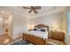 Bedroom with beautiful tray ceiling, fan, and a view into the bathroom at 5208 Parisienne Pl # 202B33, Sarasota, FL 34238