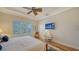 Bedroom with a fan, a flat screen TV, and a great view from the window at 5208 Parisienne Pl # 202B33, Sarasota, FL 34238