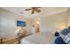 Bedroom with a fan, a flat screen TV, and a view into the bathroom at 5208 Parisienne Pl # 202B33, Sarasota, FL 34238