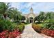 Community clubhouse entrance featuring well-manicured landscaping and inviting pathway at 5208 Parisienne Pl # 202B33, Sarasota, FL 34238