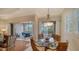 Dining room with glass table that opens onto a screened lanai with seating at 5208 Parisienne Pl # 202B33, Sarasota, FL 34238