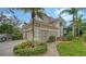 Beautiful exterior view with a brick walkway leading to the front entrance and lush landscaping at 5208 Parisienne Pl # 202B33, Sarasota, FL 34238