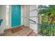 Inviting front entrance with a vibrant turquoise door, brick steps, and manicured landscaping at 5208 Parisienne Pl # 202B33, Sarasota, FL 34238