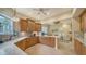 Charming kitchen featuring tile flooring, wood cabinets, and a breakfast bar that connects to living space at 5208 Parisienne Pl # 202B33, Sarasota, FL 34238