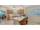 Well-lit kitchen featuring a center island with barstool seating and wood cabinets at 5208 Parisienne Pl # 202B33, Sarasota, FL 34238