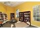 Community library with a variety of books and ample lighting from large windows at 5208 Parisienne Pl # 202B33, Sarasota, FL 34238