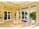 Grand lobby with a tiered fountain, tile flooring, and doors leading to the fitness center at 5208 Parisienne Pl # 202B33, Sarasota, FL 34238