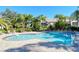 Inviting community pool area with ample seating and lush landscaping for a resort-style experience at 5208 Parisienne Pl # 202B33, Sarasota, FL 34238