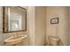 Elegant powder room with unique wallpaper, a framed mirror, and a pedestal sink at 5208 Parisienne Pl # 202B33, Sarasota, FL 34238