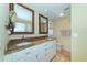 Double vanity bathroom with granite countertops and white cabinets at 521 Wedge Ln, Longboat Key, FL 34228