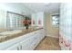 Bathroom with double vanity and flamingo shower curtain at 521 Wedge Ln, Longboat Key, FL 34228