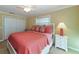 Bedroom with coral bedding and white nightstand at 521 Wedge Ln, Longboat Key, FL 34228