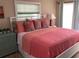 Bedroom with coral bedding and plenty of natural light at 521 Wedge Ln, Longboat Key, FL 34228