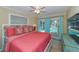 Bedroom with coral bedding and sliding doors leading to the pool at 521 Wedge Ln, Longboat Key, FL 34228