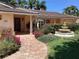 Inviting front entrance with fountain and lush landscaping at 521 Wedge Ln, Longboat Key, FL 34228