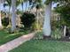 Brick pathway leads to the home through lush landscaping at 521 Wedge Ln, Longboat Key, FL 34228