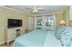 Main bedroom with TV, king bed, and pool access at 521 Wedge Ln, Longboat Key, FL 34228