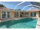 Refreshing pool with covered patio, adjacent to the house at 521 Wedge Ln, Longboat Key, FL 34228