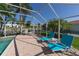 Spacious pool deck with blue lounge chairs and canal views at 521 Wedge Ln, Longboat Key, FL 34228