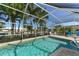 Inviting screened pool with canal views and lounge chairs at 521 Wedge Ln, Longboat Key, FL 34228