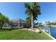 Peaceful waterfront view with lush landscaping and canal access at 521 Wedge Ln, Longboat Key, FL 34228