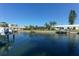 Waterfront property with boat dock and lush landscaping, offering serene canal views at 521 Wedge Ln, Longboat Key, FL 34228