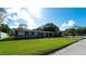 Single story home with lush green lawn and mature trees at 5415 8Th Avenue W Dr, Bradenton, FL 34209