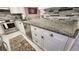 Kitchen features granite countertops and white cabinets at 5940 7Th W Ave # 5940, Bradenton, FL 34209