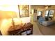 Living room features a sofa and view into kitchen at 5940 7Th W Ave # 5940, Bradenton, FL 34209