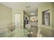 Dining area with glass-top table and wicker chairs, adjacent to the kitchen at 6115 39Th W Ave, Bradenton, FL 34209