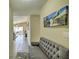 Inviting entryway with a gray bench and a large beach-themed wall art at 6115 39Th W Ave, Bradenton, FL 34209