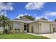 Tan one-story house with a two-car garage and landscaped yard at 6115 39Th W Ave, Bradenton, FL 34209