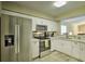 Modern kitchen with stainless steel appliances and white cabinets at 6115 39Th W Ave, Bradenton, FL 34209