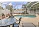 Screened pool area with patio furniture and a large pool at 6115 39Th W Ave, Bradenton, FL 34209