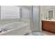 Bathroom with shower, bathtub, and double vanity at 6172 42Nd Street E St, Bradenton, FL 34203