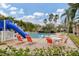 Inviting community pool with a slide, lounge chairs, and tables at 6172 42Nd Street E St, Bradenton, FL 34203