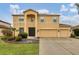 Two-story house with two-car garage, landscaping, and large windows at 6172 42Nd Street E St, Bradenton, FL 34203