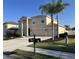 Two-story house with beige exterior, two-car garage, and palm trees at 6172 42Nd Street E St, Bradenton, FL 34203