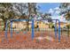 Community playground with swings and wood chip ground cover at 6172 42Nd Street E St, Bradenton, FL 34203