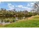 Serene pond view with lush green landscaping at 6172 42Nd Street E St, Bradenton, FL 34203