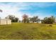 Backyard view showing home, shed, and grassy area at 6222 Brentwood Ave, Sarasota, FL 34231