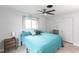 Bright bedroom with teal bedding, ceiling fan, and ample natural light at 6222 Brentwood Ave, Sarasota, FL 34231