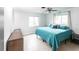 King bedroom with teal bedding and a ceiling fan at 6222 Brentwood Ave, Sarasota, FL 34231