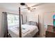 Bedroom with a post bed, ceiling fan, and view of backyard at 6222 Brentwood Ave, Sarasota, FL 34231