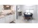 Small dining area with a teal table and four navy blue chairs at 6222 Brentwood Ave, Sarasota, FL 34231