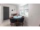 Small dining area with a teal table and four navy blue chairs at 6222 Brentwood Ave, Sarasota, FL 34231