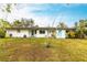 Ranch style home with light teal doors and a grassy yard at 6222 Brentwood Ave, Sarasota, FL 34231