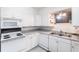 Clean kitchen with white cabinets and modern appliances at 6222 Brentwood Ave, Sarasota, FL 34231